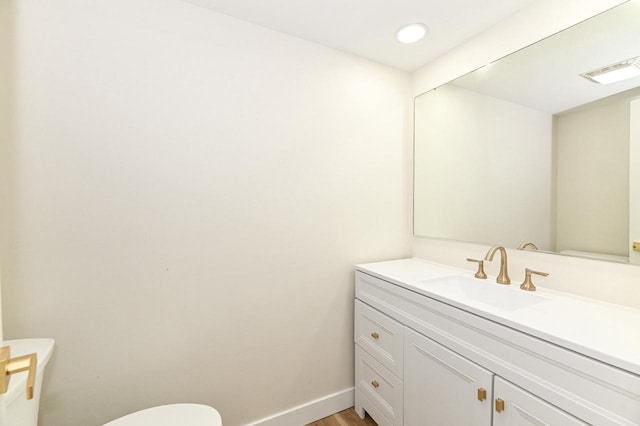 9530 W Debbie Ln, Milwaukee, WI 53224 - bathroom featuring toilet, vanity, wood finished floors, and baseboards