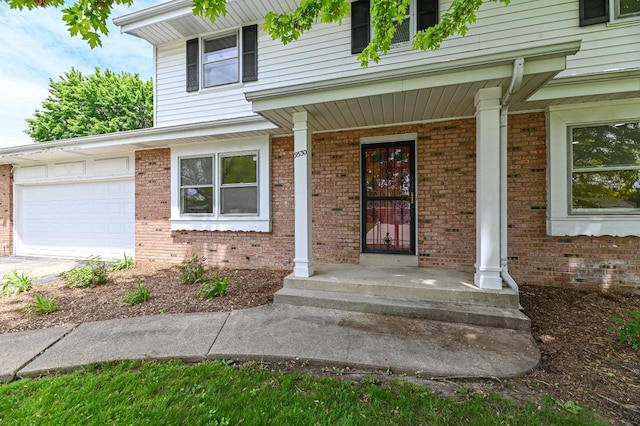 9530 W Debbie Ln, Milwaukee, WI 53224 - entrance to property with a garage, brick siding, concrete driveway, and a porch
