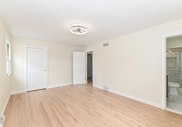 9530 W Debbie Ln, Milwaukee, WI 53224 - unfurnished bedroom featuring light wood-type flooring, baseboards, and ensuite bathroom