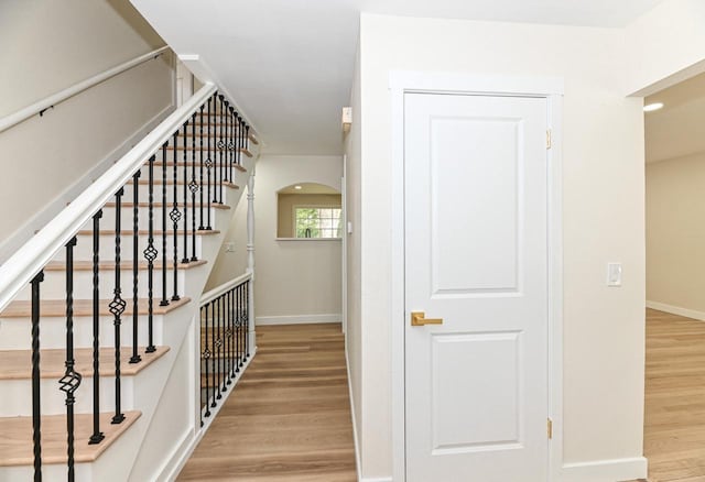 9530 W Debbie Ln, Milwaukee, WI 53224 - staircase with wood finished floors, baseboards, and arched walkways