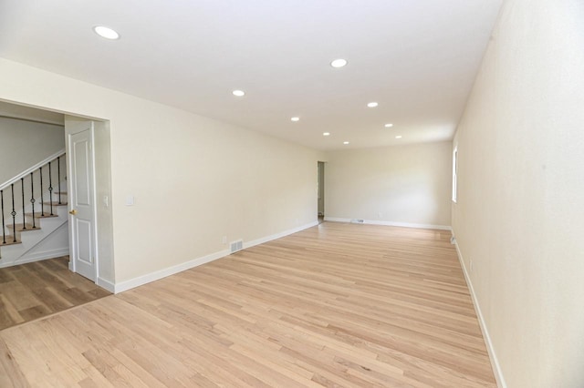 9530 W Debbie Ln, Milwaukee, WI 53224 - spare room with stairway, recessed lighting, light wood finished floors, and baseboards