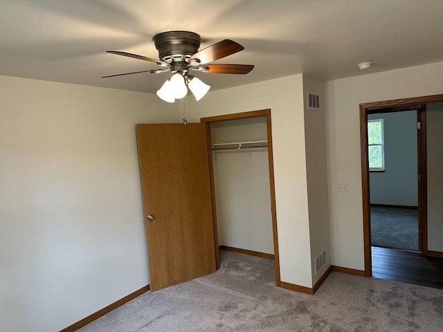 513 Oak Grove Dr, Necedah, WI 54646 - unfurnished bedroom with carpet floors, a closet, baseboards, and a ceiling fan