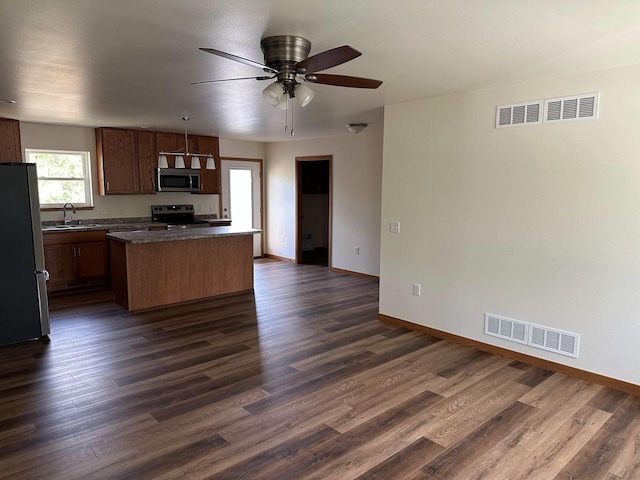 513 Oak Grove Dr, Necedah, WI 54646 - kitchen featuring stainless steel appliances, a kitchen island, ceiling fan, and dark wood-type flooring
