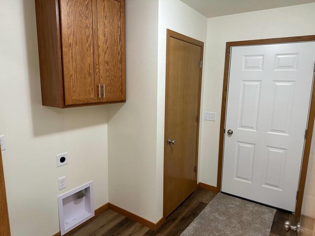 513 Oak Grove Dr, Necedah, WI 54646 - laundry area with electric dryer hookup, dark wood finished floors, cabinet space, and baseboards