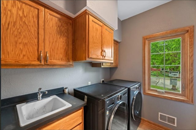 2605 River Ridge Drive, Waukesha, WI 53189 - laundry room with cabinet space, washing machine and dryer, wood finished floors, a textured wall, and baseboards