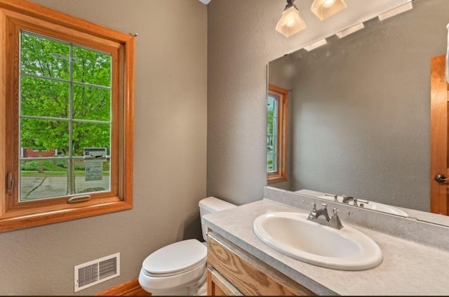 2605 River Ridge Drive, Waukesha, WI 53189 - bathroom featuring vanity, toilet, and a textured wall
