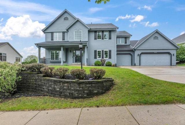 2605 River Ridge Drive, Waukesha, WI 53189 - view of front of property featuring covered porch, driveway, a garage, and a front lawn