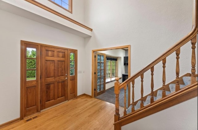 2605 River Ridge Drive, Waukesha, WI 53189 - entryway featuring light wood-style flooring, stairs, a towering ceiling, and baseboards