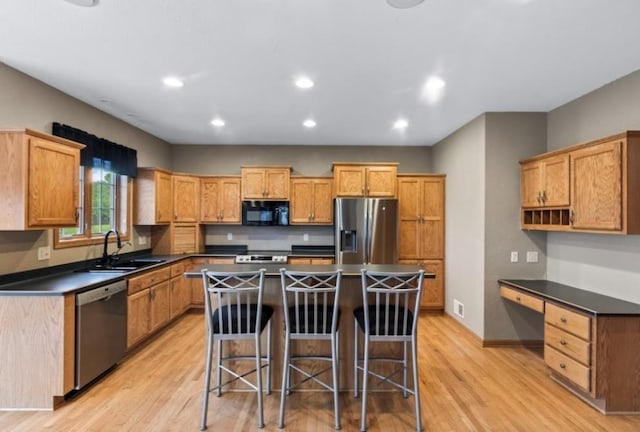 2605 River Ridge Drive, Waukesha, WI 53189 - kitchen with appliances with stainless steel finishes, dark countertops, light wood-style flooring, a sink, and recessed lighting