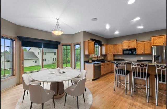 2605 River Ridge Drive, Waukesha, WI 53189 - kitchen with stainless steel appliances, a sink, light wood finished floors, recessed lighting, and plenty of natural light