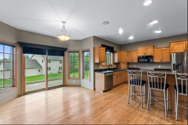 2605 River Ridge Drive, Waukesha, WI 53189 - kitchen featuring appliances with stainless steel finishes, a sink, baseboards, dark countertops, and recessed lighting