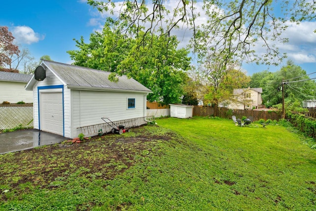 320 Frederick St, Waukesha, WI 53186 - view of yard featuring an outdoor structure, a garage, and concrete driveway
