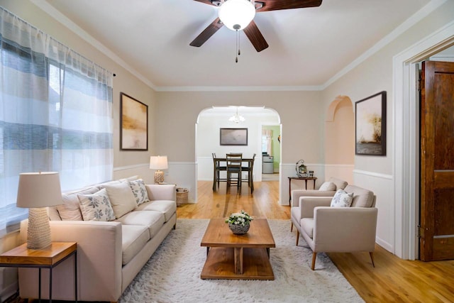 320 Frederick St, Waukesha, WI 53186 - living area with arched walkways, wood finished floors, a ceiling fan, and crown molding