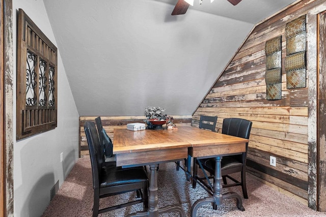 15393 Jacklin Heights Cir, Crivitz, WI 54114 - carpeted dining room featuring lofted ceiling, wooden walls, and a ceiling fan