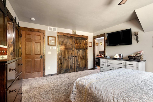 15393 Jacklin Heights Cir, Crivitz, WI 54114 - bedroom featuring light colored carpet, a closet, a barn door, and baseboards