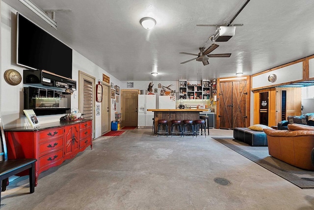 15393 Jacklin Heights Cir, Crivitz, WI 54114 - living room featuring a dry bar, concrete flooring, and ceiling fan
