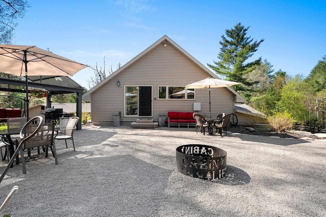15393 Jacklin Heights Cir, Crivitz, WI 54114 - rear view of property with a gazebo, a patio area, outdoor dining area, entry steps, and an outdoor fire pit