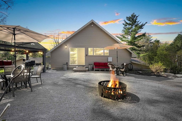 15393 Jacklin Heights Cir, Crivitz, WI 54114 - back of property featuring entry steps, a patio area, an outdoor fire pit, outdoor dining space, and a gazebo