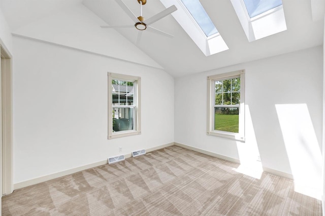 427 Robbins St, Seymour, WI 54165 - empty room with a skylight, vaulted ceiling, light colored carpet, a ceiling fan, and baseboards