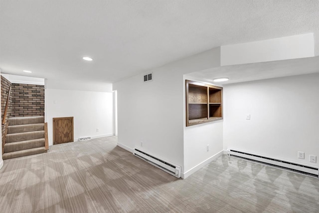 427 Robbins St, Seymour, WI 54165 - finished below grade area featuring a baseboard radiator, recessed lighting, baseboards, and wood finished floors