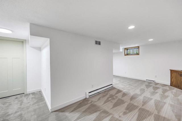 427 Robbins St, Seymour, WI 54165 - below grade area with baseboard heating, light carpet, recessed lighting, and baseboards