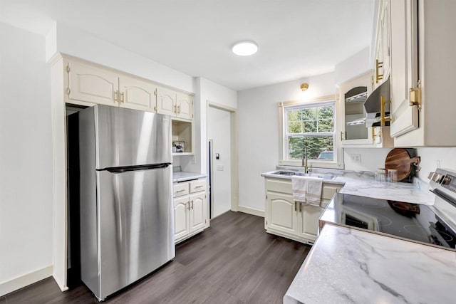 427 Robbins St, Seymour, WI 54165 - kitchen with freestanding refrigerator, a sink, light stone counters, range with electric cooktop, and dark wood-style flooring
