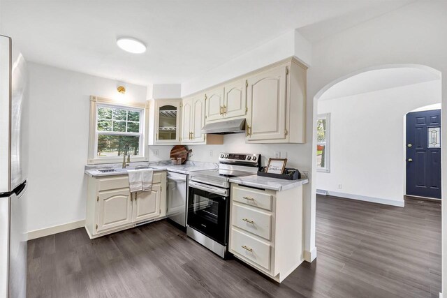 427 Robbins St, Seymour, WI 54165 - kitchen featuring appliances with stainless steel finishes, a sink, light countertops, dark wood finished floors, and under cabinet range hood
