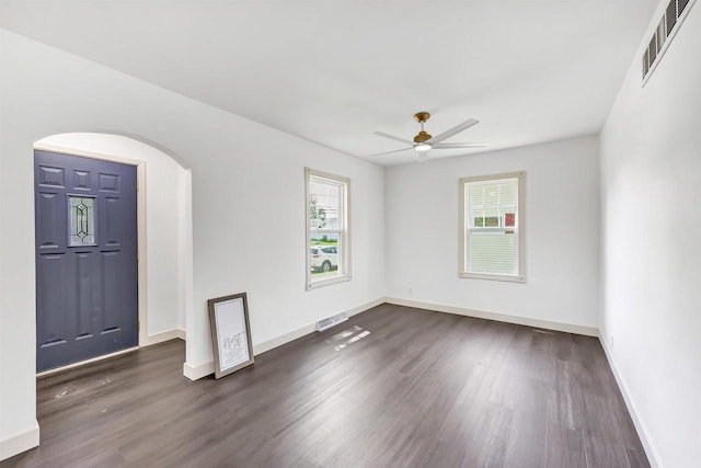 427 Robbins St, Seymour, WI 54165 - unfurnished room with dark wood finished floors, a ceiling fan, baseboards, and arched walkways