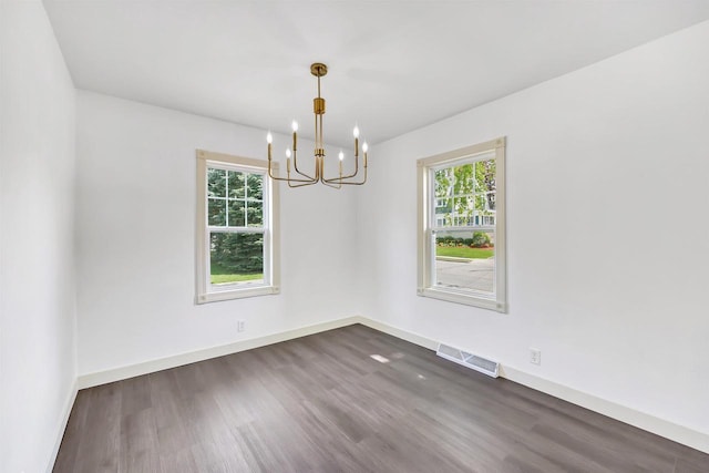 427 Robbins St, Seymour, WI 54165 - unfurnished room with a chandelier, plenty of natural light, and dark wood-style flooring