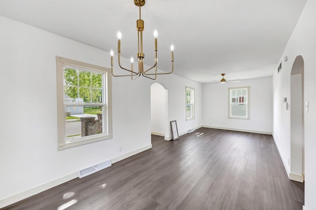 427 Robbins St, Seymour, WI 54165 - spare room with arched walkways, plenty of natural light, and dark wood finished floors