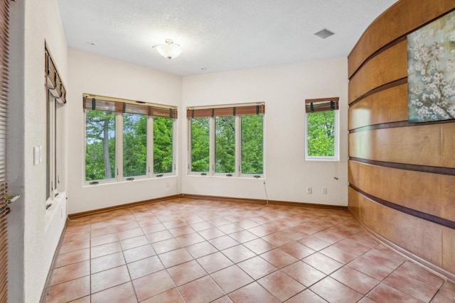 58 Oakridge Ct, Fond Du Lac, WI 54937 - unfurnished room with a textured ceiling, baseboards, and light tile patterned floors