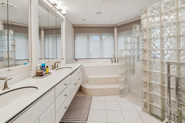 58 Oakridge Ct, Fond Du Lac, WI 54937 - bathroom featuring a garden tub, a walk in shower, tile patterned flooring, and double vanity