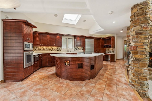 58 Oakridge Ct, Fond Du Lac, WI 54937 - kitchen with light countertops, appliances with stainless steel finishes, a skylight, a sink, and recessed lighting