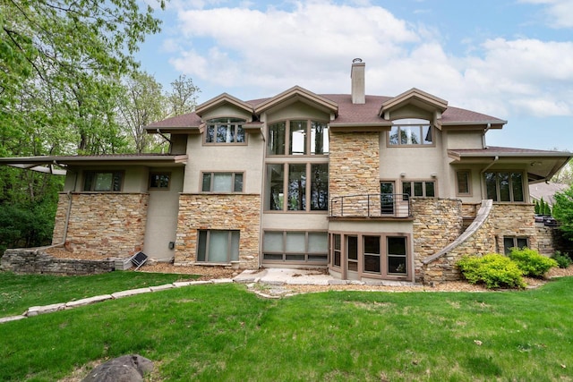 58 Oakridge Ct, Fond Du Lac, WI 54937 - back of house featuring stone siding, stucco siding, a chimney, and a balcony