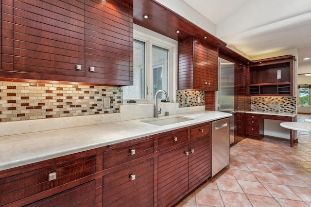 58 Oakridge Ct, Fond Du Lac, WI 54937 - kitchen featuring a sink, decorative backsplash, light tile patterned floors, light countertops, and stainless steel dishwasher