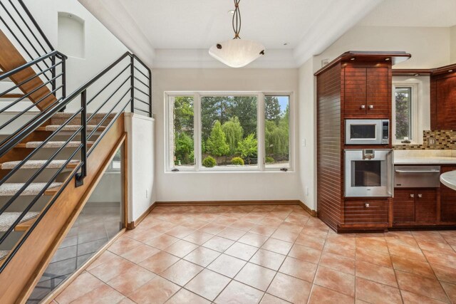 58 Oakridge Ct, Fond Du Lac, WI 54937 - kitchen with appliances with stainless steel finishes, a warming drawer, light tile patterned flooring, and backsplash