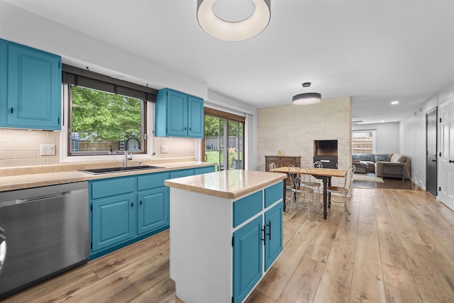 522 Valley Rd, Madison, WI 53714 - kitchen with stainless steel dishwasher, blue cabinetry, a sink, light countertops, and recessed lighting