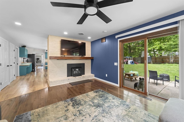 522 Valley Rd, Madison, WI 53714 - living area with a fireplace, wood-type flooring, a ceiling fan, baseboards, and recessed lighting