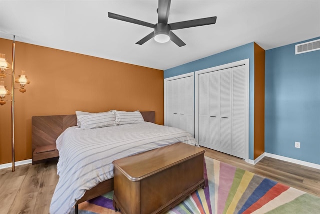 522 Valley Rd, Madison, WI 53714 - bedroom featuring multiple closets, wood finished floors, baseboards, and a ceiling fan