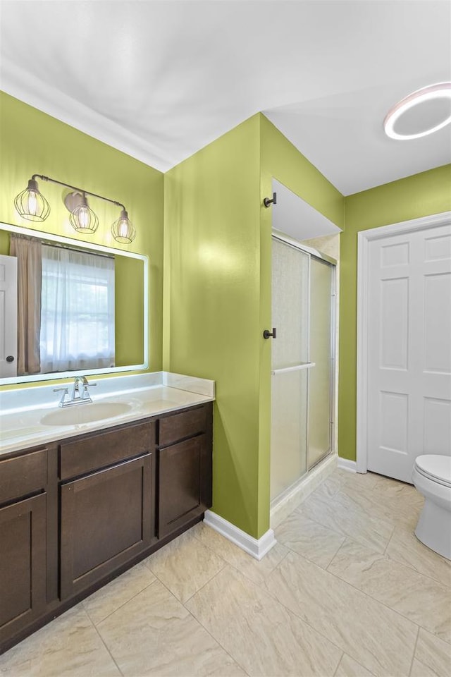 522 Valley Rd, Madison, WI 53714 - bathroom featuring a shower stall, vanity, toilet, and baseboards