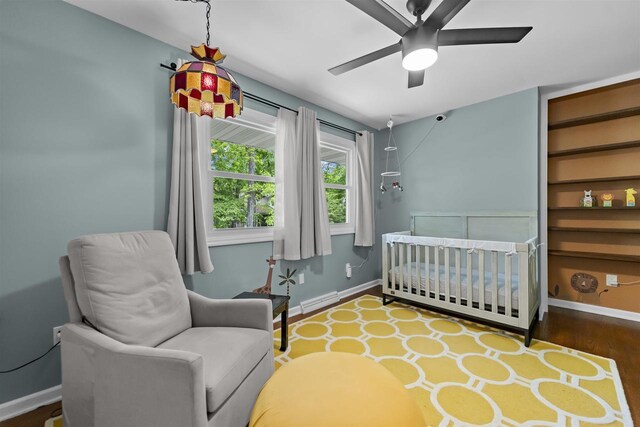 522 Valley Rd, Madison, WI 53714 - bedroom with baseboards, wood finished floors, and a nursery area