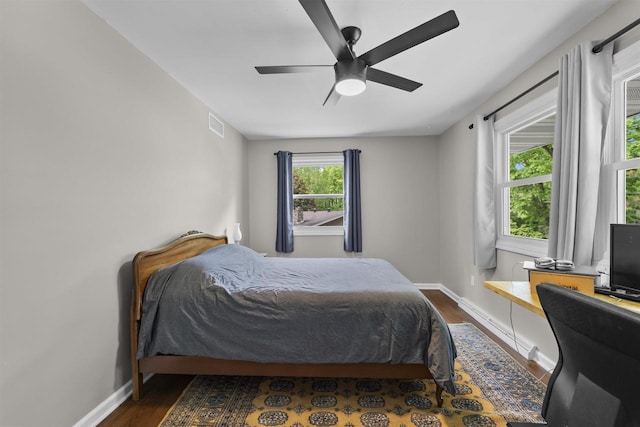 522 Valley Rd, Madison, WI 53714 - bedroom featuring baseboards, dark wood-style flooring, ceiling fan, and an office area