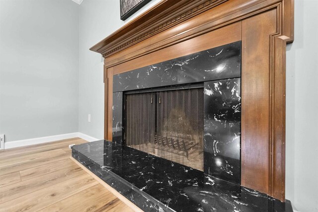 522 Valley Rd, Madison, WI 53714 - detailed view of wood finished floors, baseboards, and a fireplace with raised hearth