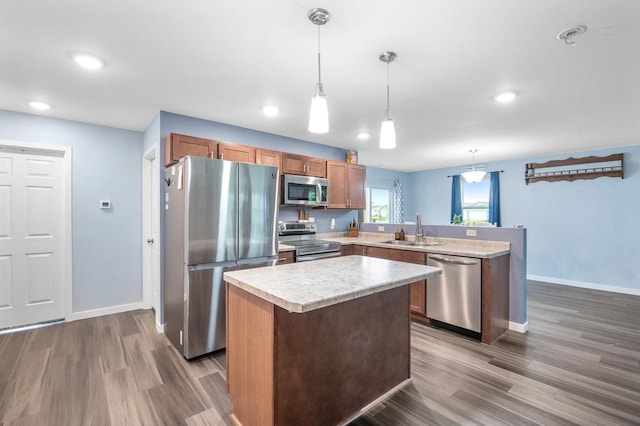 900 Edgewater Dr, Merrill, WI 54452 - kitchen featuring stainless steel appliances, a sink, baseboards, a peninsula, and wood finished floors