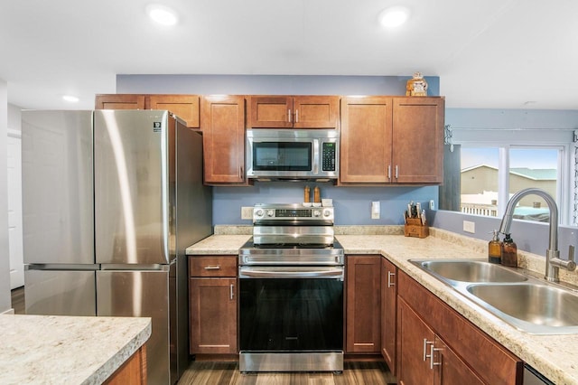 900 Edgewater Dr, Merrill, WI 54452 - kitchen featuring stainless steel appliances, a sink, light countertops, recessed lighting, and dark wood-type flooring