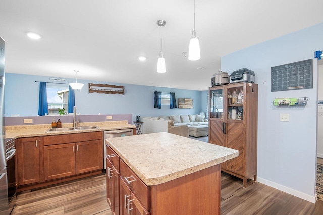 900 Edgewater Dr, Merrill, WI 54452 - kitchen featuring a sink, wood finished floors, brown cabinets, light countertops, and recessed lighting