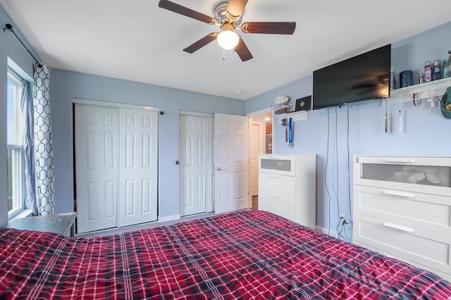 900 Edgewater Dr, Merrill, WI 54452 - unfurnished bedroom featuring multiple closets, a ceiling fan, and baseboards
