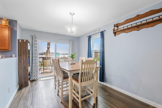 900 Edgewater Dr, Merrill, WI 54452 - dining area featuring dark wood-type flooring and baseboards
