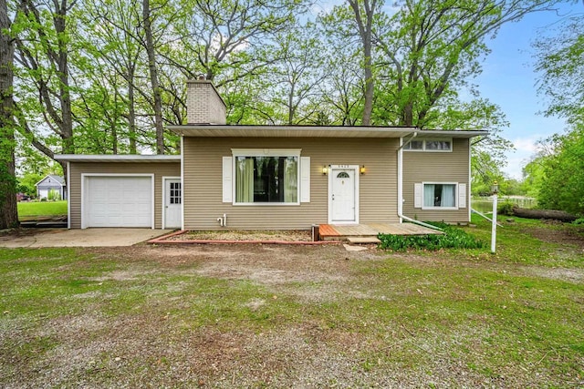 6429 S US Highway 45, Oshkosh, WI 54902 - view of front of property with a chimney, a front lawn, driveway, and a garage