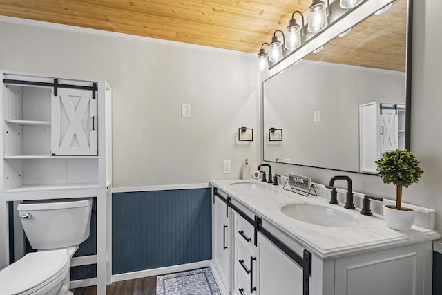 6429 S US Highway 45, Oshkosh, WI 54902 - bathroom featuring wooden ceiling, toilet, a wainscoted wall, double vanity, and wood finished floors